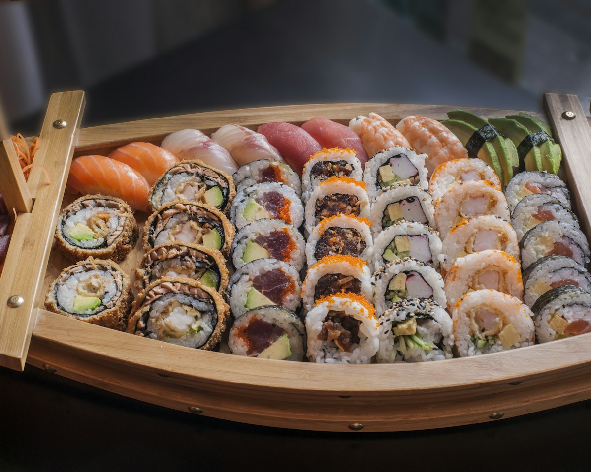 A sushi boat with a selection of rolls and nigiri to share